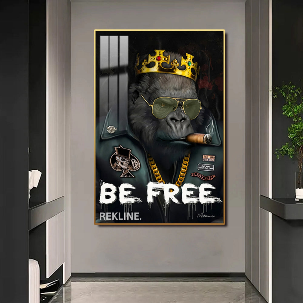 Close-up of a crowned gorilla smoking a cigar on LED-lit canvas with “BE FREE” graffiti background