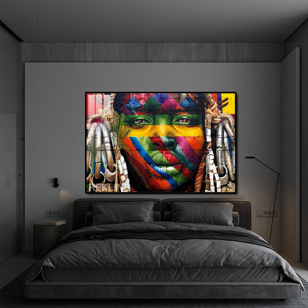 Abstract painting of a woman’s face with colorful tribal stripes on a brick-red background, backlit by hidden LEDs