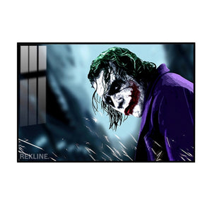 Close-up of Joker’s face with green hair, red smile, and purple coat on a dark background, backlit by LED strips