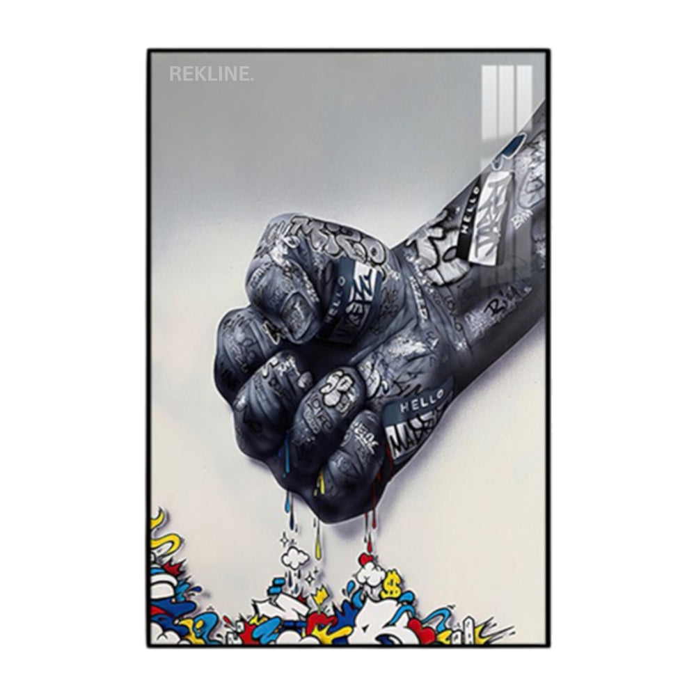 Raised fist covered in tags, dripping colorful graffiti on canvas