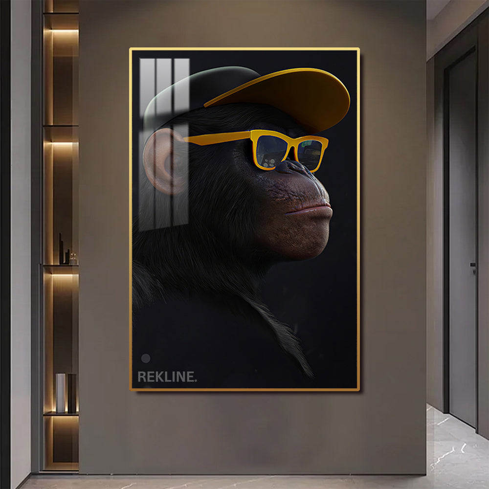 Side-view monkey in cap and yellow sunglasses, illuminated canvas.