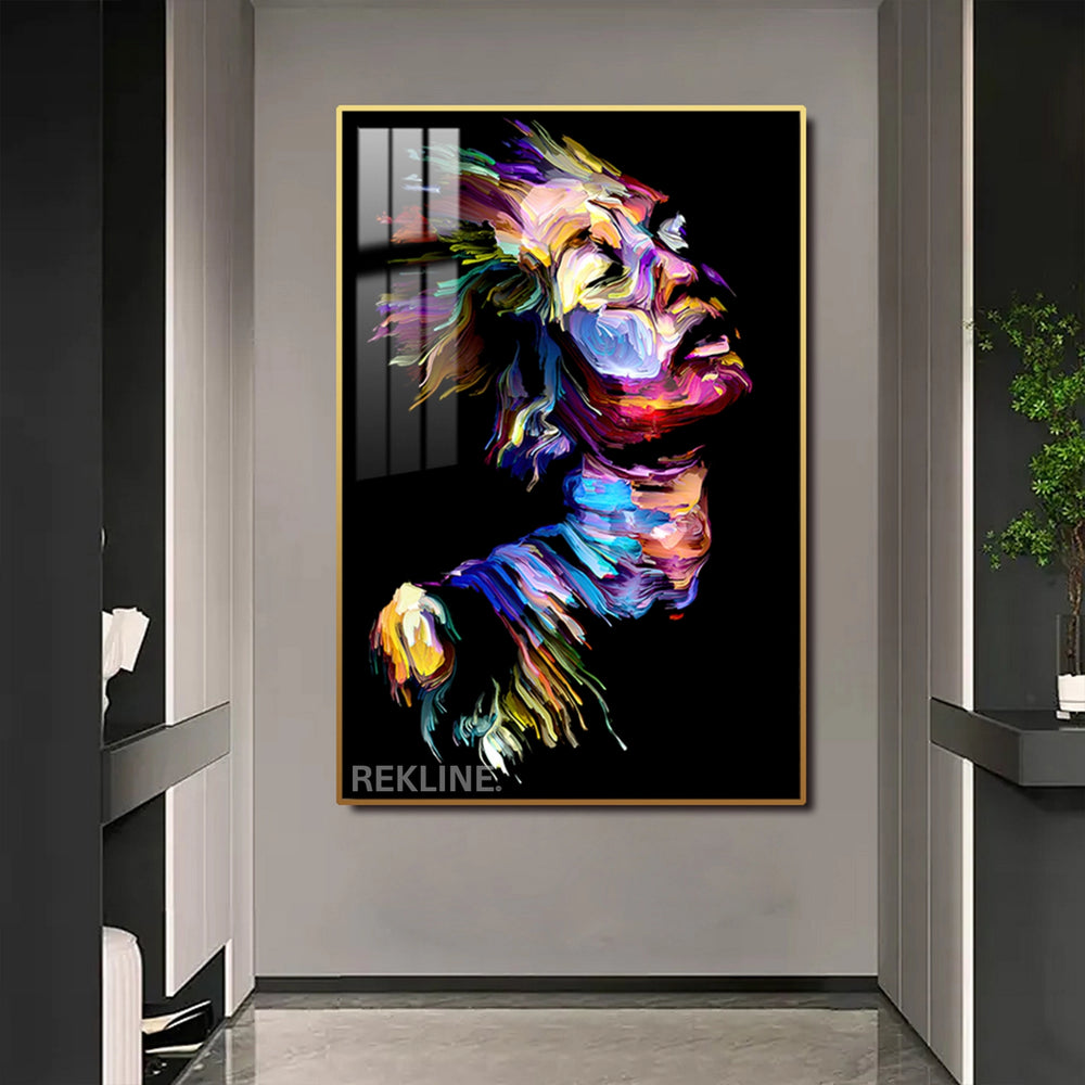 Abstract portrait of a woman’s face with multicolored brushstrokes on black canvas, softly illuminated by LEDs